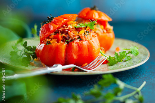 Delicious stuffed tomatoes in shape of pumpkin with rice, vegetables and meat. Concept homemade healthy eating.