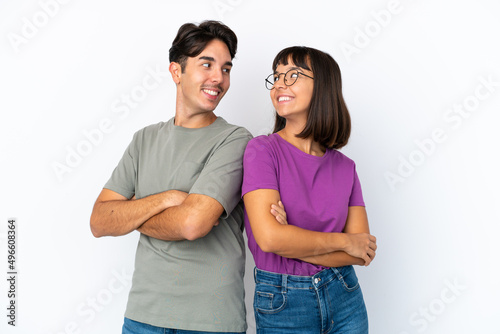 Young couple isolated on isolated white background looking over the shoulder with a smile