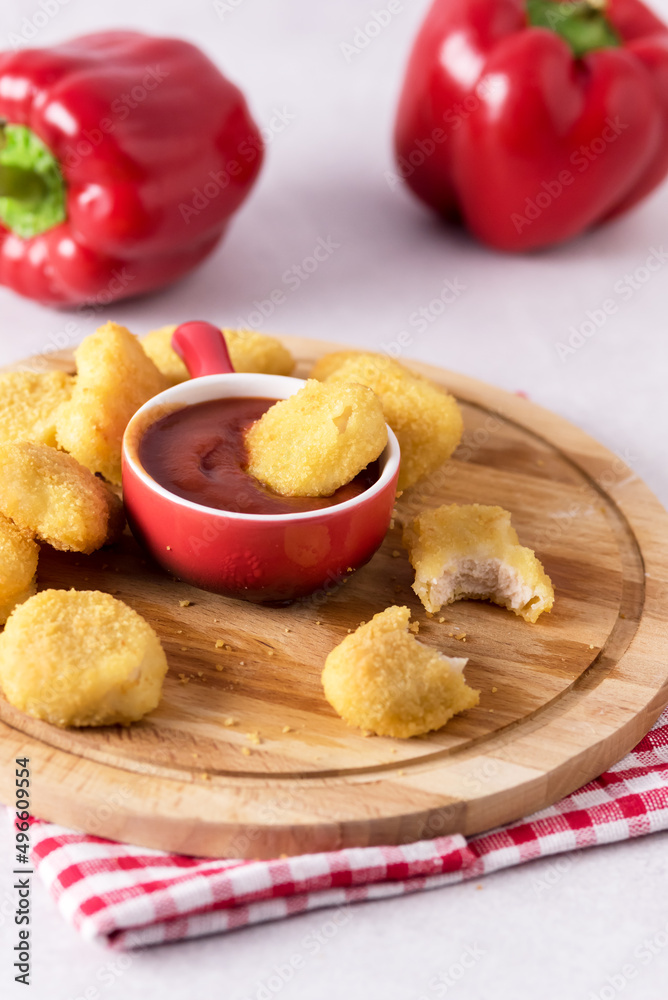 Tasty Chicken Nuggets with Tomato Sauce on Wooden Tray Light Gray Background Vertical