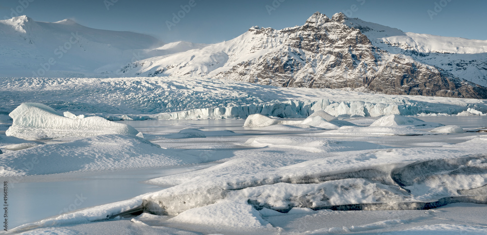 Snow-covered icebergs in frozen Fjallsarlon glacial lake. Fjallsarlon, Southern Iceland.