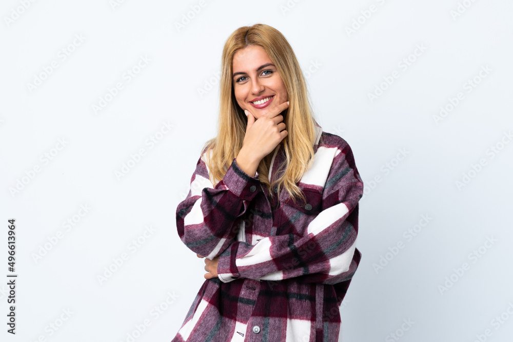 Young Uruguayan blonde woman over isolated white background smiling Young Uruguayan blonde woman over isolated white background smiling