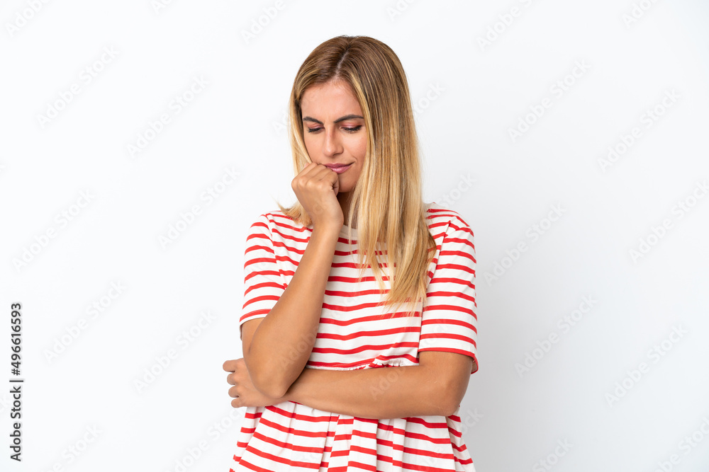 Blonde Uruguayan girl isolated on white background having doubts Blonde Uruguayan girl isolated on white background having doubts