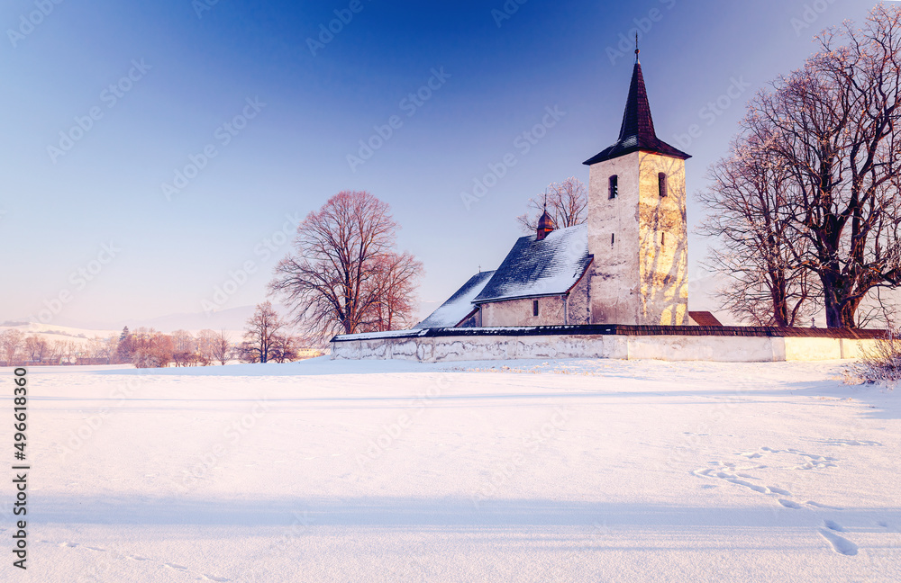 Winter landscape with countryside church.