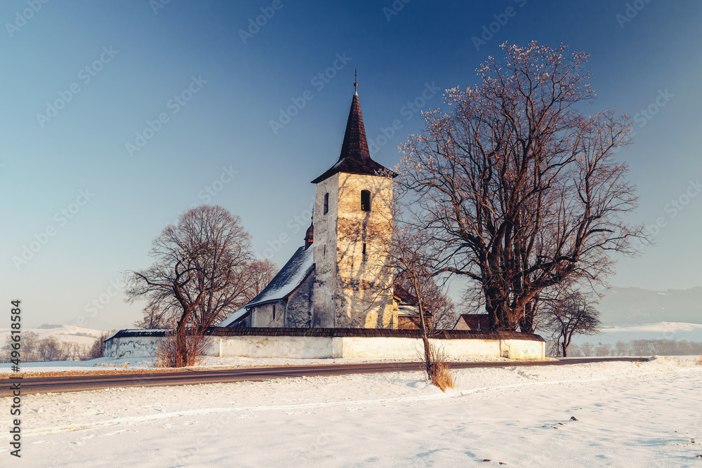 Winter landscape with countryside church.