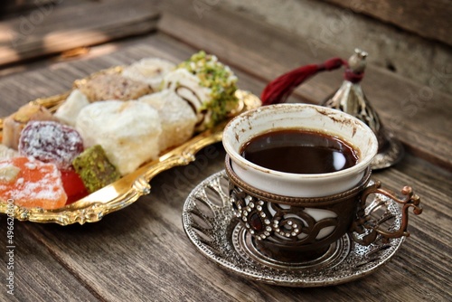 Indian desserts and hot black coffee photo