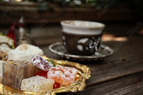Indian desserts and hot black coffee photo