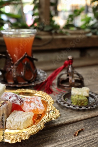 Indian desserts sweet and fruit tea on wood background