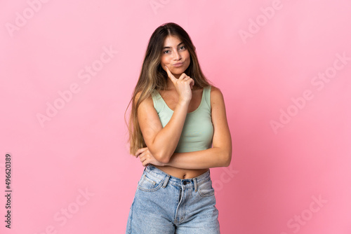 Young caucasian woman isolated on pink background and thinking © luismolinero