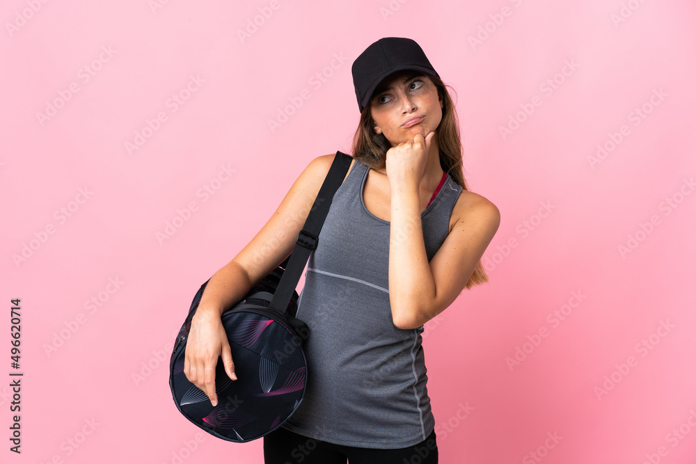 Young sport woman with sport bag isolated on pink background having doubts Young sport woman with sport bag isolated on pink background having doubts
