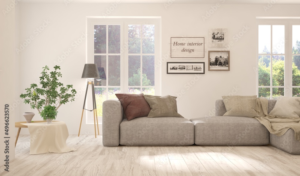 Fototapeta premium White living room with sofa and summer landscape in window. Scandinavian interior design. 3D illustration