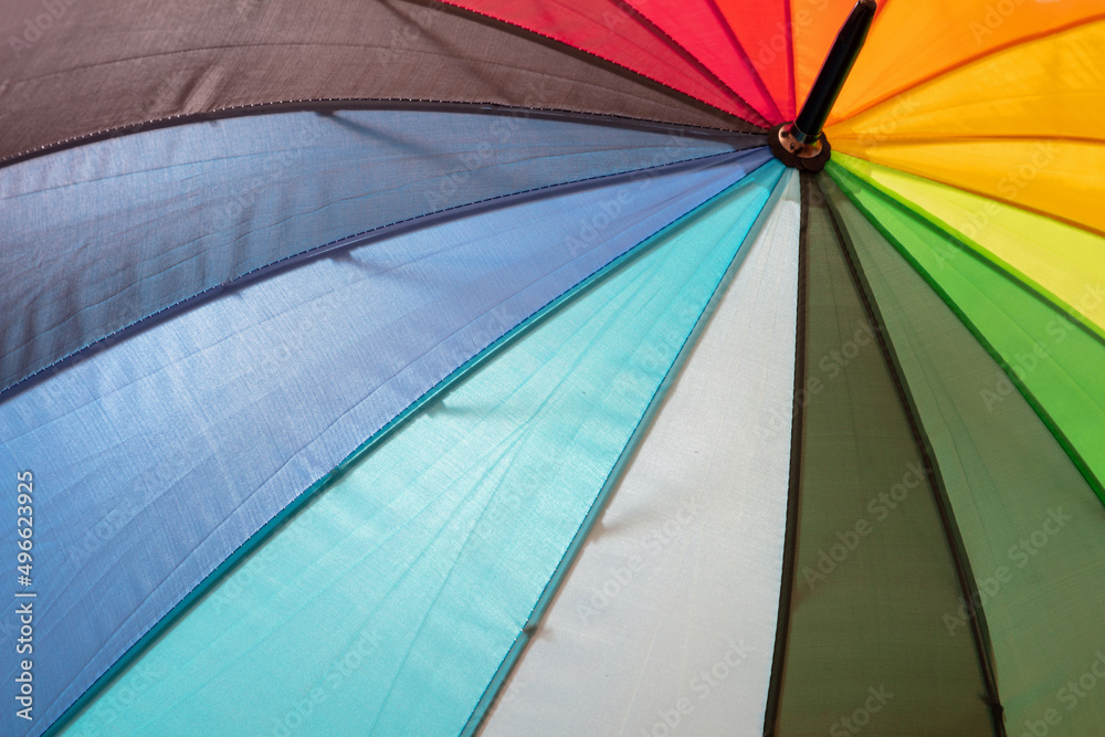 Rainbow color umbrella background. Multicolored spectrum colours sunshade, open, sunny day