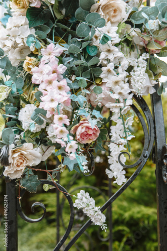 Decorative artificial flowers displayed on the street, hanging photo