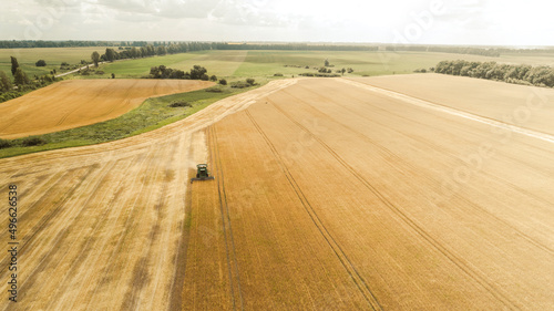 Aerial view combine harvester harvesting on the field © LALSSTOCK