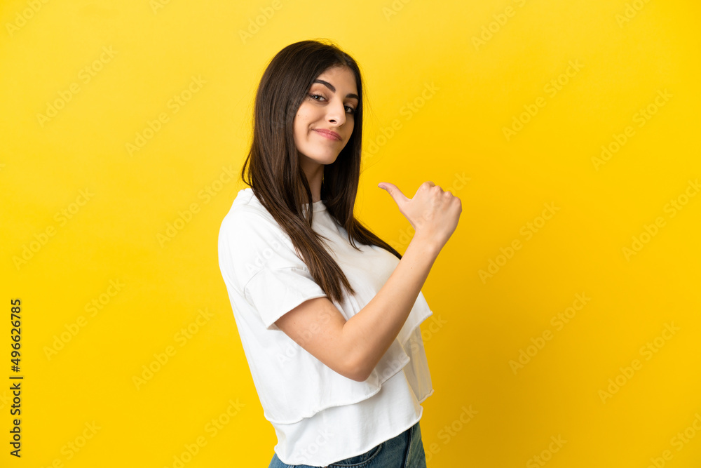 Young caucasian woman isolated on yellow background proud and self-satisfied Young caucasian woman isolated on yellow background proud and self-satisfied