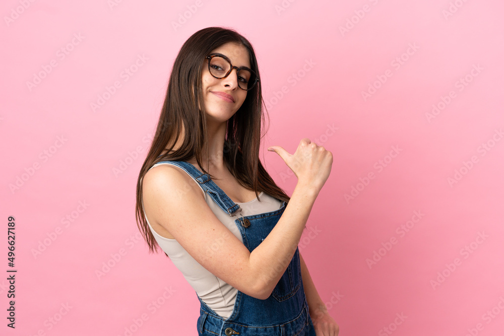 Young caucasian woman isolated on pink background proud and self-satisfied Young caucasian woman isolated on pink background proud and self-satisfied