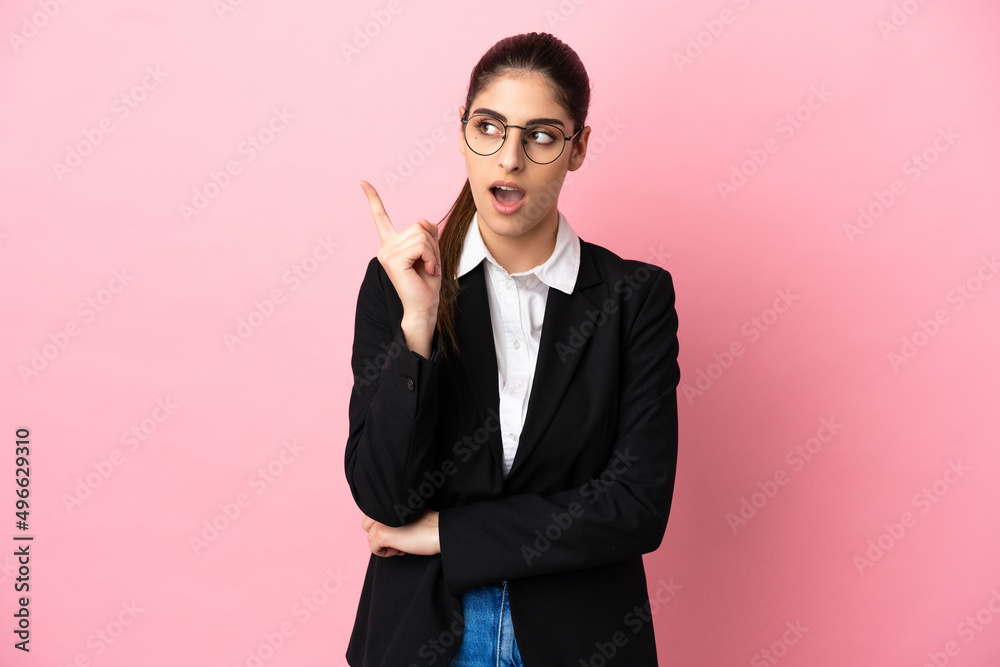 Young caucasian business woman isolated on pink background thinking an idea pointing the finger up Young caucasian business woman isolated on pink background thinking an idea pointing the finger up