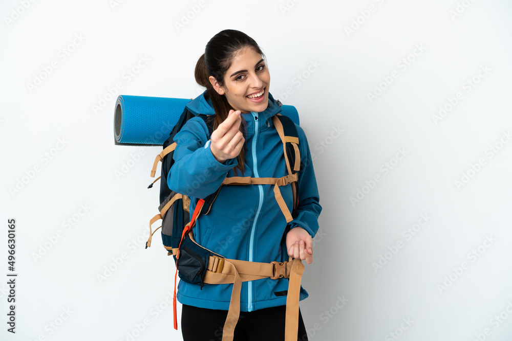 Young mountaineer man with a big backpack over isolated background making money gesture Young mountaineer man with a big backpack over isolated background making money gesture