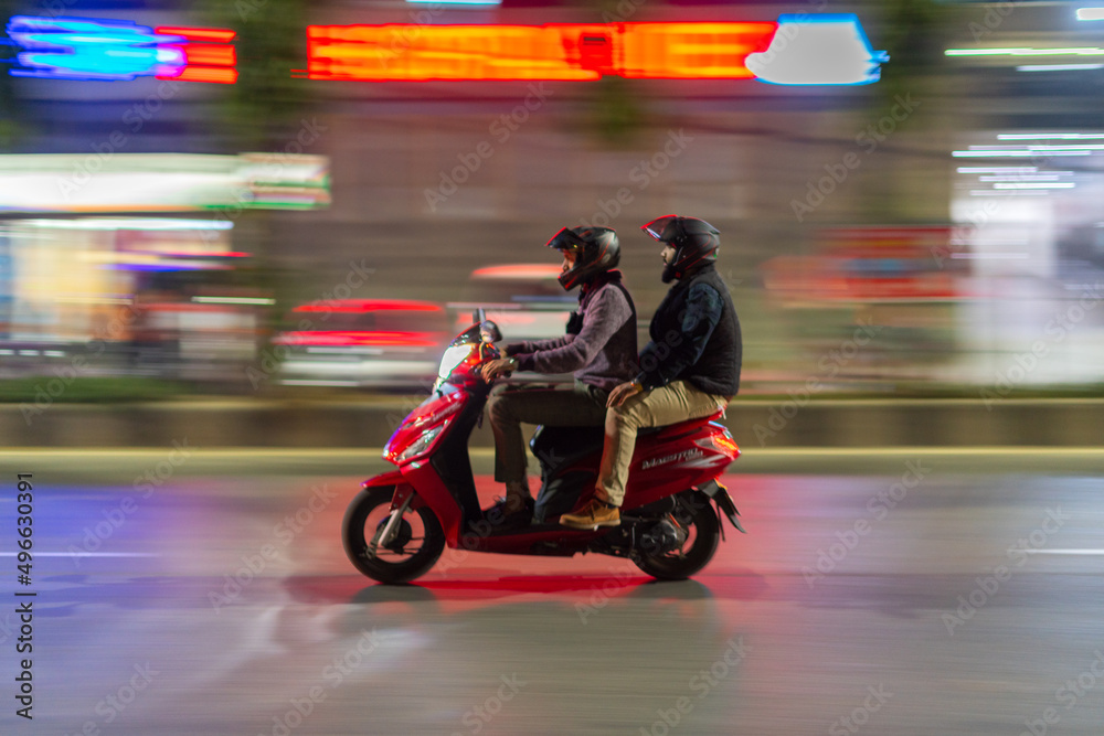 Motorcycle rider and passenger going to their destination. It's a panning picture. 