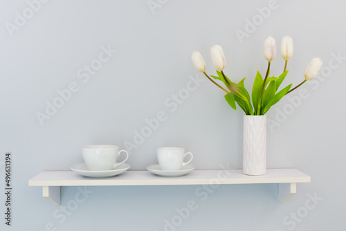 Two cups with a bouquet of tulips