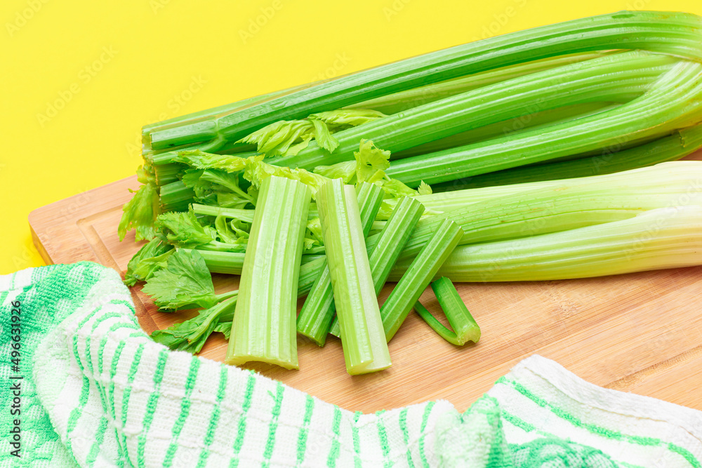 Fresh Celery Stem and Chopped Celery Sticks on Wooden Cutting Board. Vegan and Vegetarian Culture. Raw Food. Healthy Diet with Negative Calorie Content. Slimming Food Fresh Celery Stem and Chopped Celery Sticks on Wooden Cutting Board. Vegan and Vegetarian Culture. Raw Food. Healthy Diet with Negative Calorie Content. Slimming Food