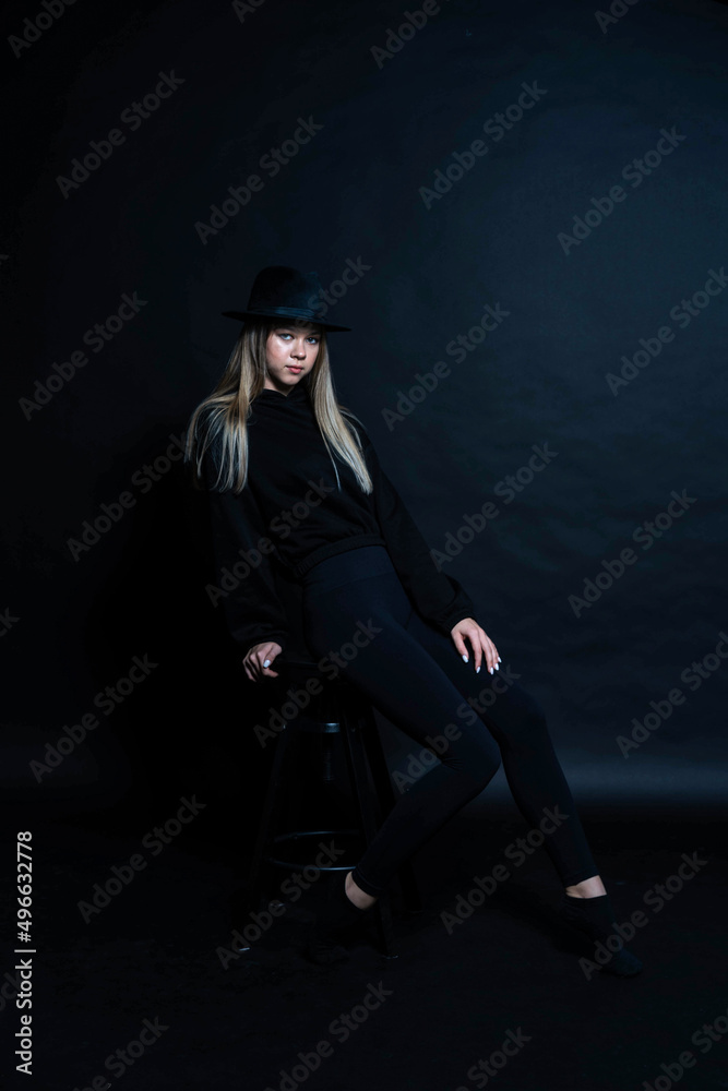 girl in black in the studio in a dark key