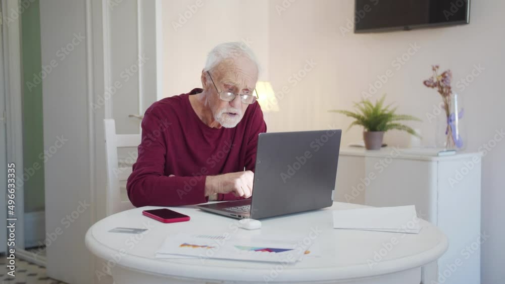 Grandpa in glasses looking for information on the Internet Grandpa in glasses looking for information on the Internet