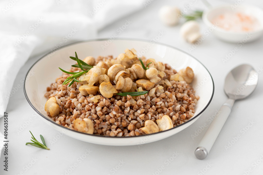 buckwheat porridge with fried mushrooms and onions in a white bowl buckwheat porridge with fried mushrooms and onions in a white bowl