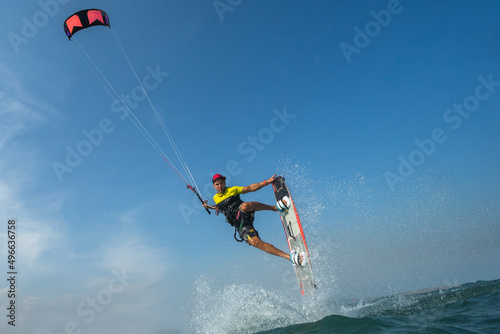 A kite surfer rides the waves
