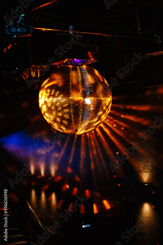 Disco ball hanging on the ceiling of the disco Rays of light are reflected from it