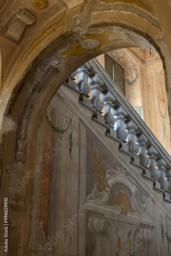 old staircase with paintings on the walls and columns