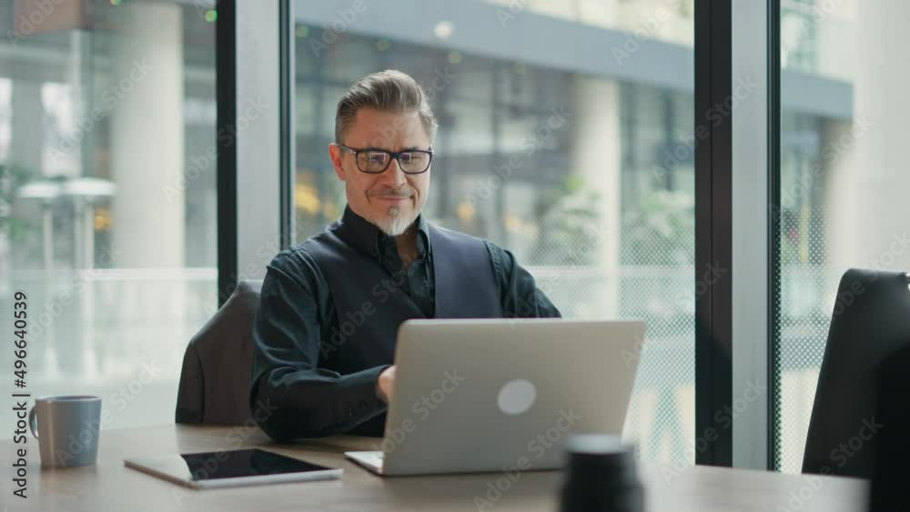 Business portrait - businessman using laptop computer in office, thinking. Happy middle aged man, entrepreneur working online. Business portrait - businessman using laptop computer in office, thinking. Happy middle aged man, entrepreneur working online.