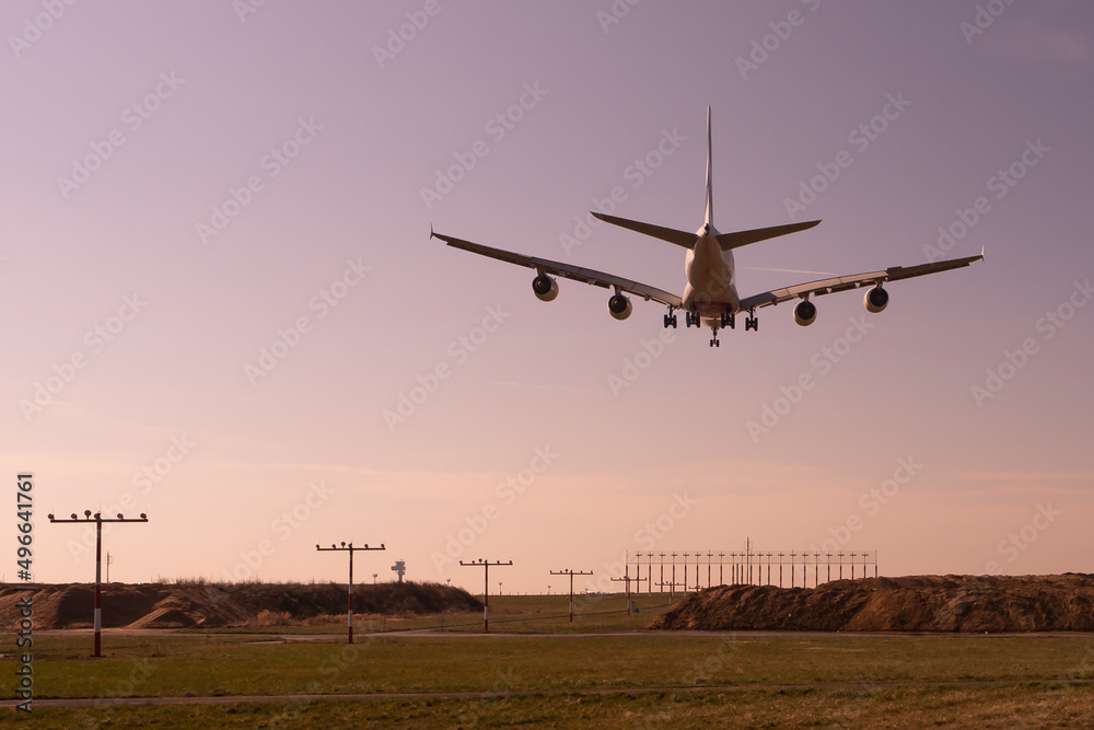 Landing plane Airbus A380 at Düsseldorf Airport in Germany at sunset Landing plane Airbus A380 at Düsseldorf Airport in Germany at sunset
