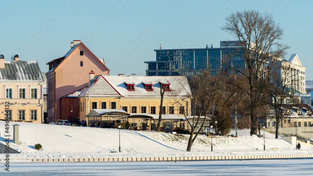 Neighborhood of old houses and modern buildings in winter. Retro versus modern style. Contrast in architecture. Neighborhood of old houses and modern buildings in winter. Retro versus modern style. Contrast in architecture.