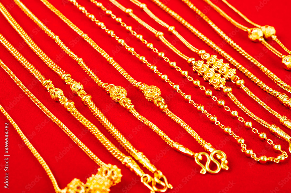 Set of gold necklace on red Velvet fabric. Set of gold necklace on red Velvet fabric.