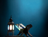 Kuran or Quran , the holy book of all Muslim shined by brighten lantern