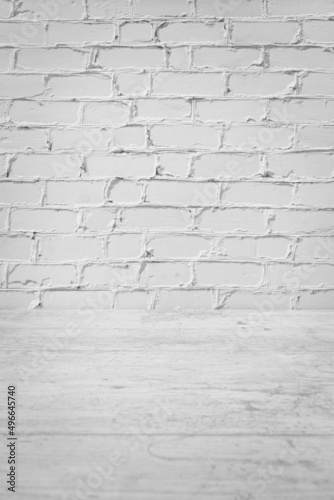Home or kitchen interior, decorative white brick wall with white wooden foreground - copy space