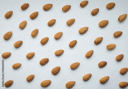 background texture of almond nuts on a white background.