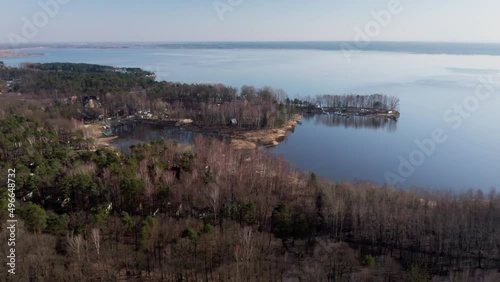 Aerial drone view of a north shore Turawa Lake near Opole, Poland, Europe. Sunny, spring day. Drone aerial view in 4k UHD real time, dolly in, wide, long shot. Basic colour correction, shot in log. photo