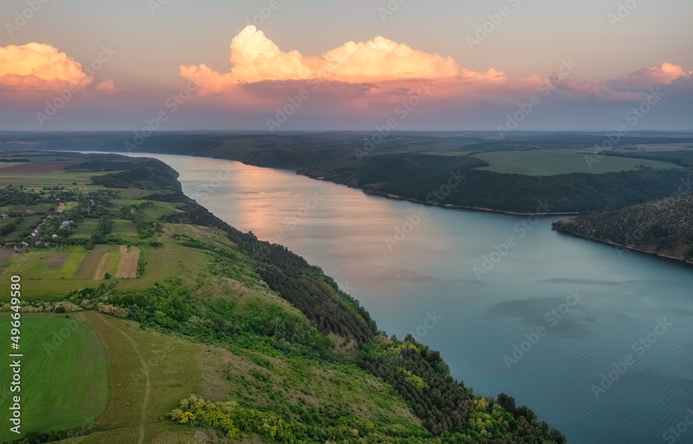 Magnificent aerial view of the Dniester River with picturesque banks during sunset. Bakota National Natural Park, Podolskie Tovtry, Ukraine. Beautiful view from a flying drone.