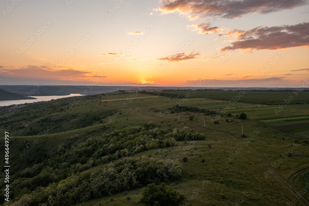 Magnificent aerial view of the Dniester River with picturesque banks during sunset. Bakota National Natural Park, Podolskie Tovtry, Ukraine. Beautiful view from a flying drone. Magnificent aerial view of the Dniester River with picturesque banks during sunset. Bakota National Natural Park, Podolskie Tovtry, Ukraine. Beautiful view from a flying drone.