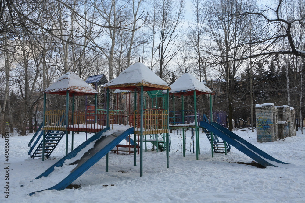 children's slides in the snow on the background of trees children's slides in the snow on the background of trees