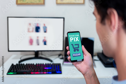 Photography Hands holding smartphone to pay for online purchases through Pix