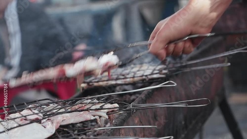  photo of traditional grills for fish inside a Moroccan seaport.lot of smoke