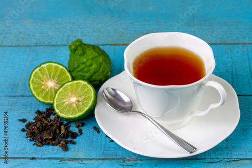 Konstfotografi Bergamot tea or Earl Grey tea in ceramic cup and fresh bergamot fruit with sliced on blue wooden table