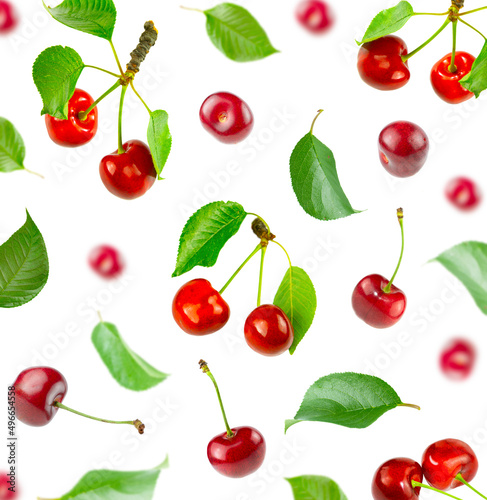 Background from flying cherries and green leaves.