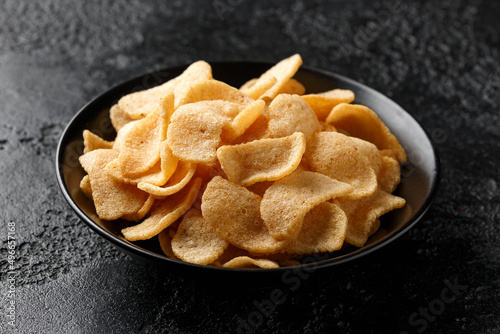 Crispy Prawn Crackers in black bowl with sweet chilli sauce photo