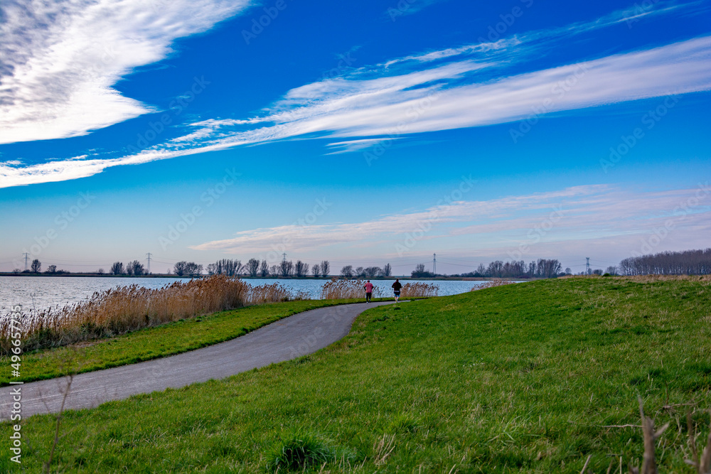Country road by the water channel beautiful view Country road by the water channel beautiful view