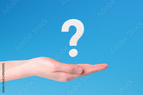 Hand holding question mark icon on blue background