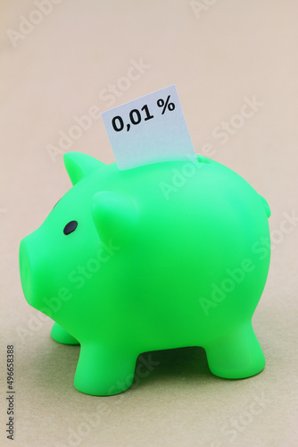 Obraz na płótnie Piggy bank with interest rate 0,01% written on white paper
w salonie