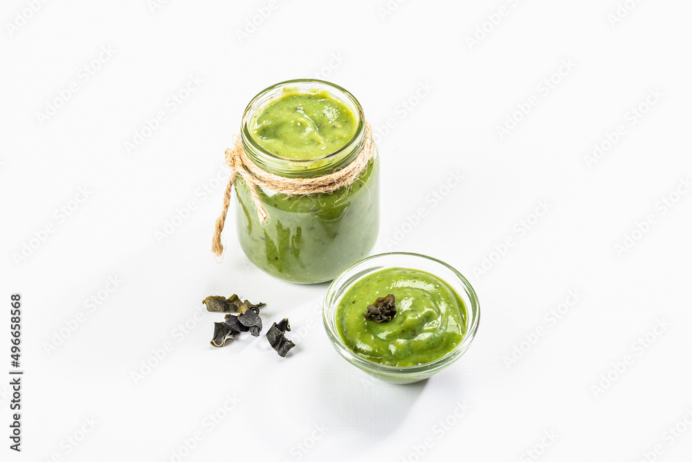 Jarred Kelp puree isolated on white background. Healthy superfood from oceanic seaweed Jarred Kelp puree isolated on white background. Healthy superfood from oceanic seaweed